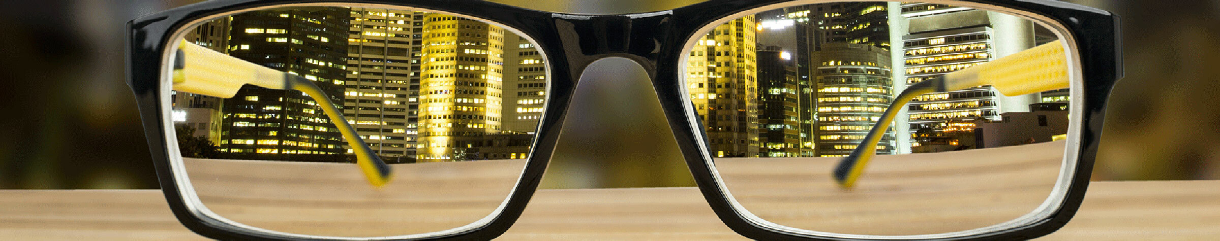 Urban city scape seen through the lenses of a pair of black rectangular glasses