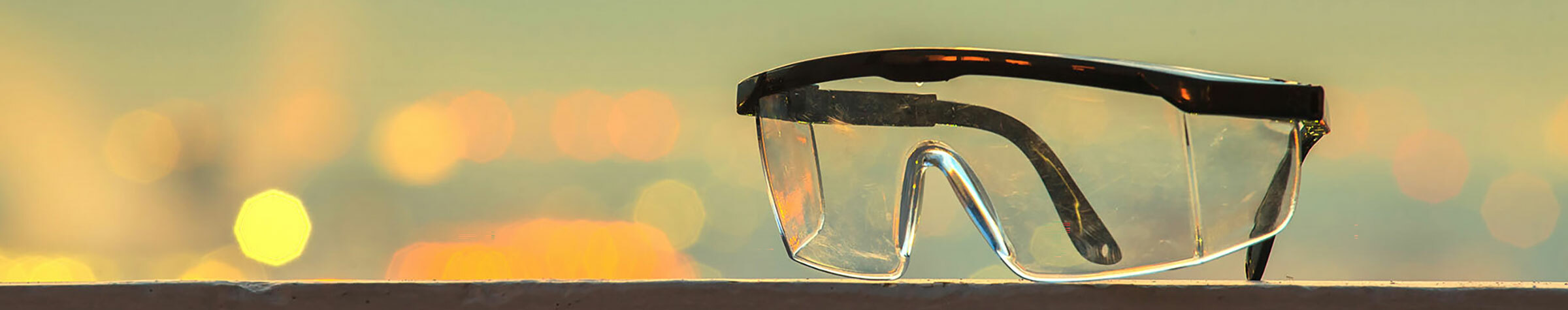 Safety glasses in front of a blurred background